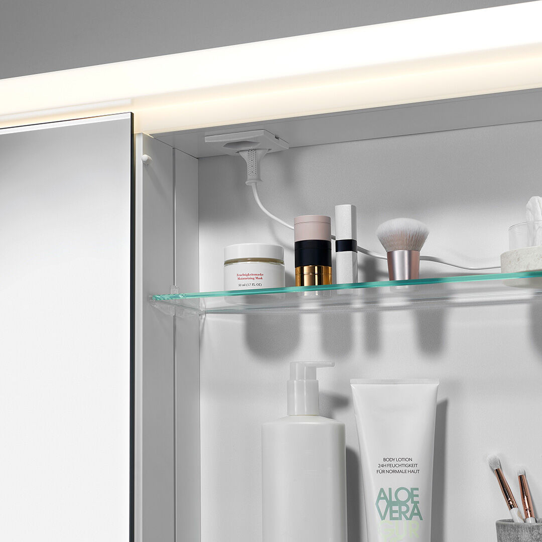 offener spiegelschrank mit leuchte oben und steckdose