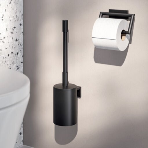 schwarze wc-bürste und papierhalter